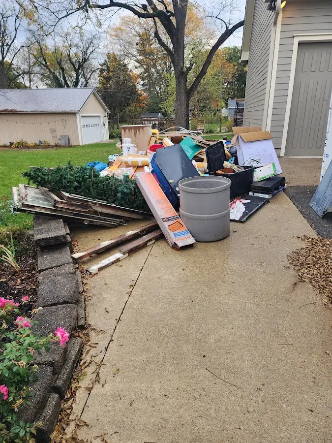 Dumpster being loaded with debris for 10 Yard Dumpster Rental in LaGrange